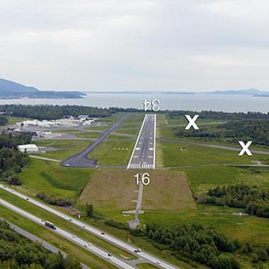 Bellingham Airport Runway located on flat grasslands near a body of water.